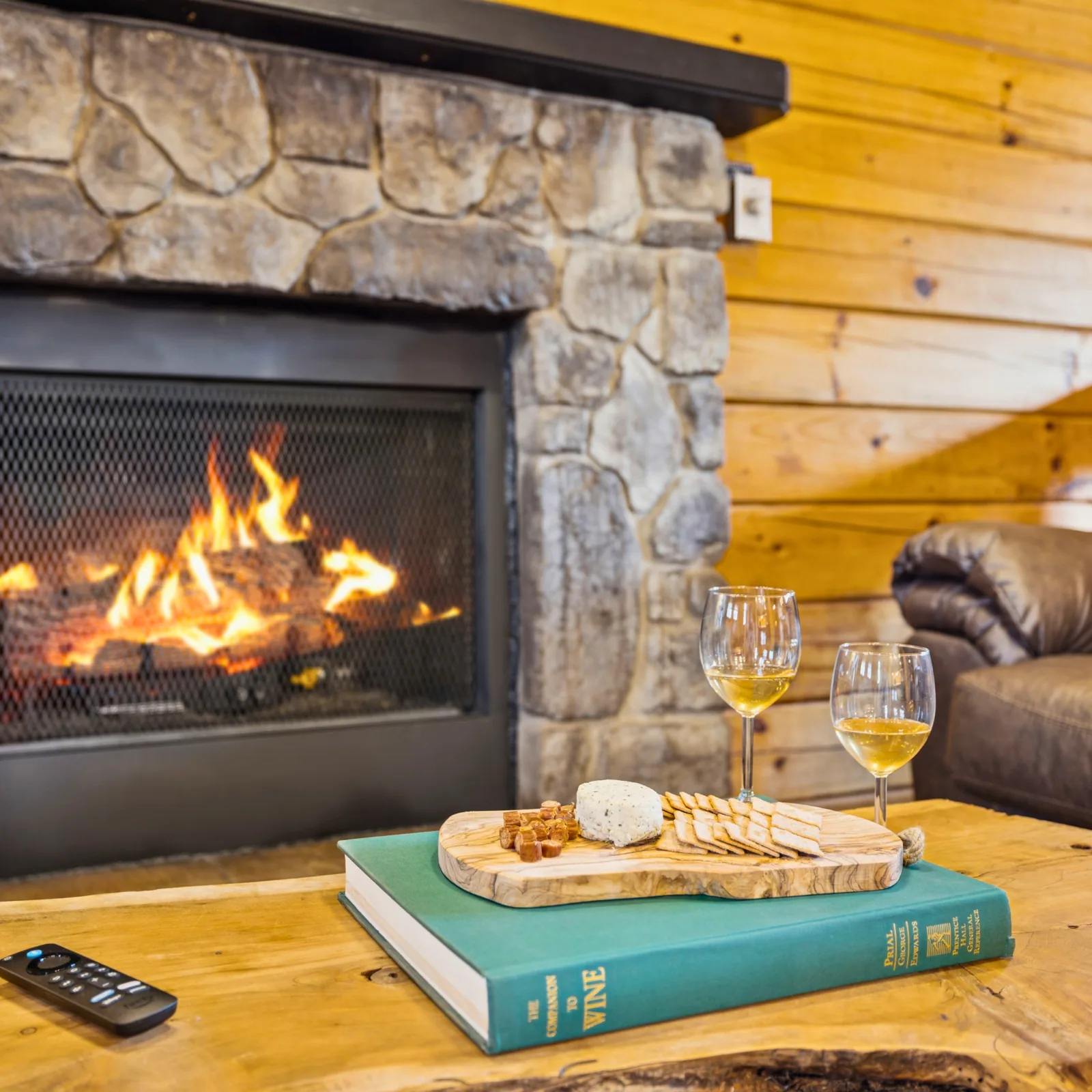 Cozy stone gas fireplace in the cabin living room